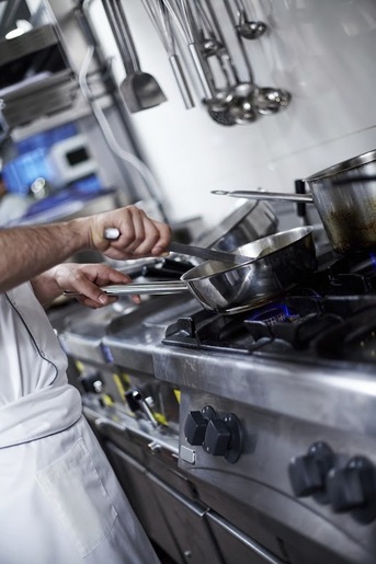 Professional kitchen showcasing food preparation, highlighting Hydraulic Supply Company's hydraulic solutions for the food and beverage industry